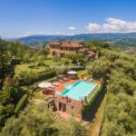 View of villas with pools in Tuscany