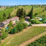 Aerial view of small Organic wine estate with farmhouse agriturismo, pool, gardens, vineyards Greve in Chianti Tuscany Italy